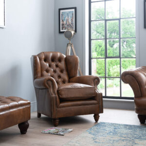 Front eye level view of the Oskar Wingback Leather Armchair in antiqued Windsor leather showcasing the deep diamond tufting and tall backrest.