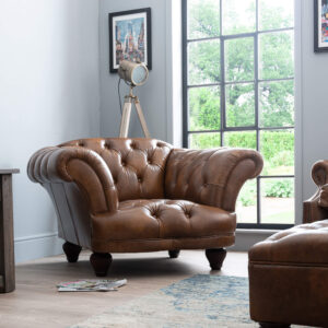 Front view of the Oskar Leather Chesterfield Armchair hand-upholstered in antiqued Windsor Ash semi-aniline leather with deep button tufting.